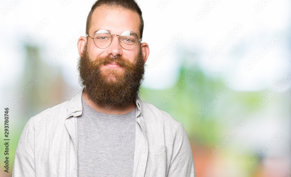 Young blond man wearing glasses Hands together and fingers crossed smiling relaxed and cheerful. Success and optimistic Young blond man wearing glasses Hands together and fingers crossed smiling relaxed and cheerful. Success and optimistic