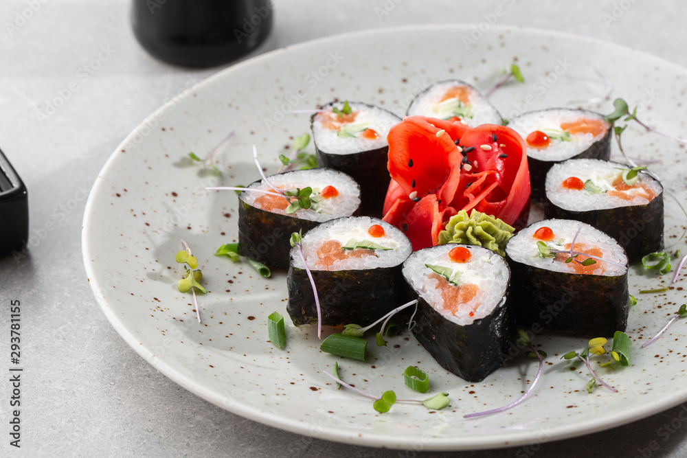Maki rolls with salmon, cucumber, caviar and cheese. Fresh hosomaki pieces with rice and nori. Closeup of delicious japanese food. Sushi menu. Top view horizontal photo on white background. Maki rolls with salmon, cucumber, caviar and cheese. Fresh hosomaki pieces with rice and nori. Closeup of delicious japanese food. Sushi menu. Top view horizontal photo on white background.