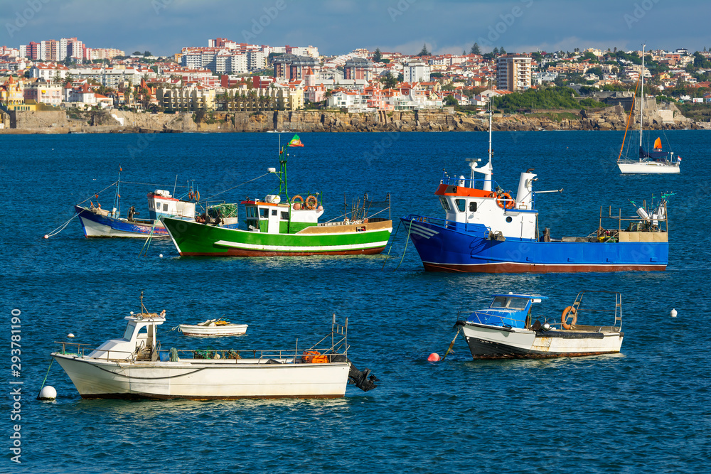 Fishing boats and luxury yachts docked at Cascais marina, coastal resort and fishing town in Lisbon district, Portugal