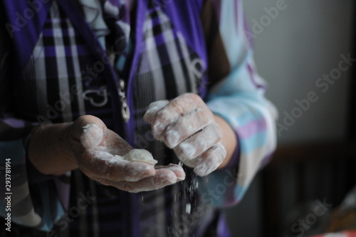 Woman molds Ukrainian dumplings.Ukrainian traditional dish