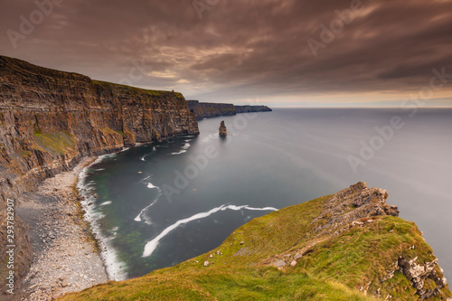 reland countryside tourist attraction in County Clare. The Cliffs of Moher and castle Ireland. Epic Irish Landscape UNESCO Global Geopark the wild atlantic way. Beautiful scenic nature hdr Ireland. photo