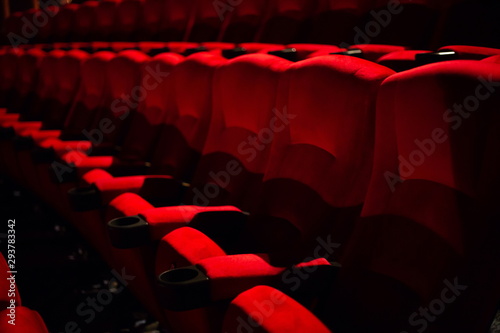 pattern empty red velvet seats in cinema auditorium .