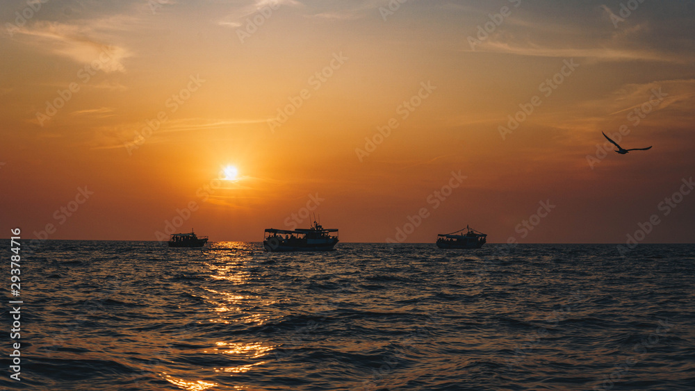 Fishing boat on the shore at sunset.  A beautiful sunset in the background. Croatia, Brijuni Island