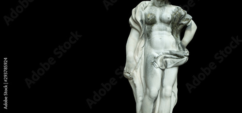The goddess of love Aphrodite (Venus). Fragment of ancient statue isolated on black background.
