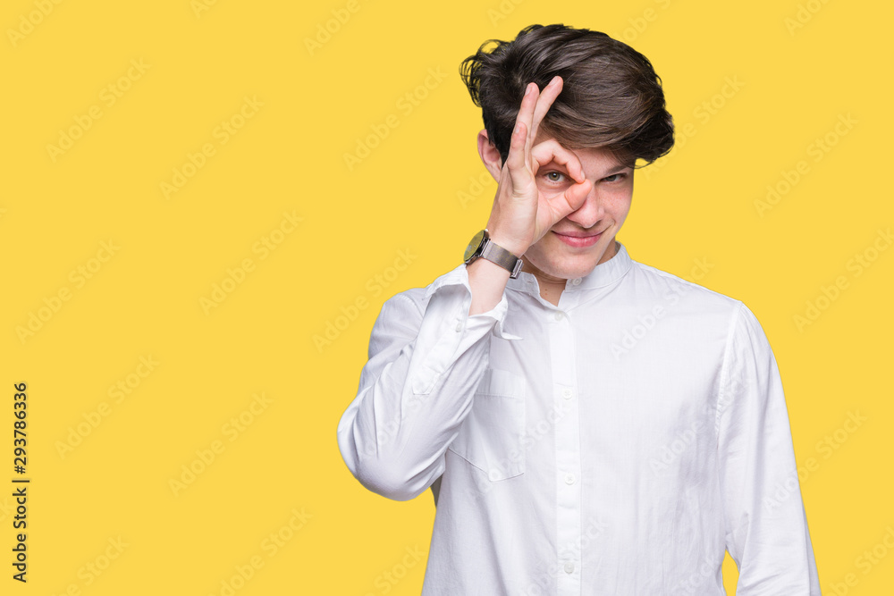 Young handsome business man over isolated background doing ok gesture with hand smiling, eye looking through fingers with happy face. Young handsome business man over isolated background doing ok gesture with hand smiling, eye looking through fingers with happy face.