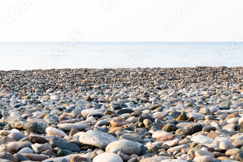 Fototapeta Naklejka Na Ścianę i Meble -  Pebble beach in the Mediterranean with clear water in the summer. Morning, Turkey.