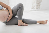 Pregnant woman doing exercises indoors