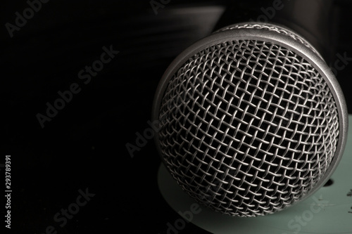 Close up head audio microphone in black background with copy space on the right © biggur