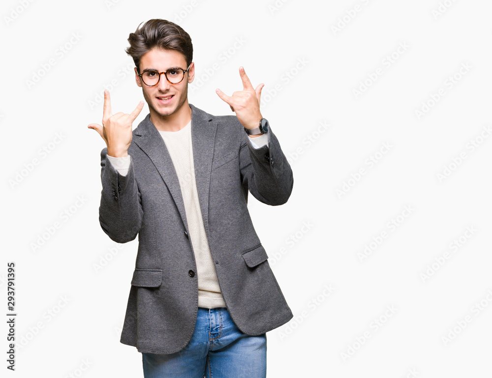 Young business man wearing glasses over isolated background shouting with crazy expression doing rock symbol with hands up. Music star. Heavy concept. Young business man wearing glasses over isolated background shouting with crazy expression doing rock symbol with hands up. Music star. Heavy concept.