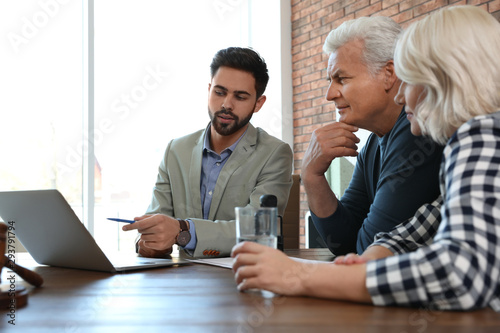 Photography Male notary working with mature couple in office