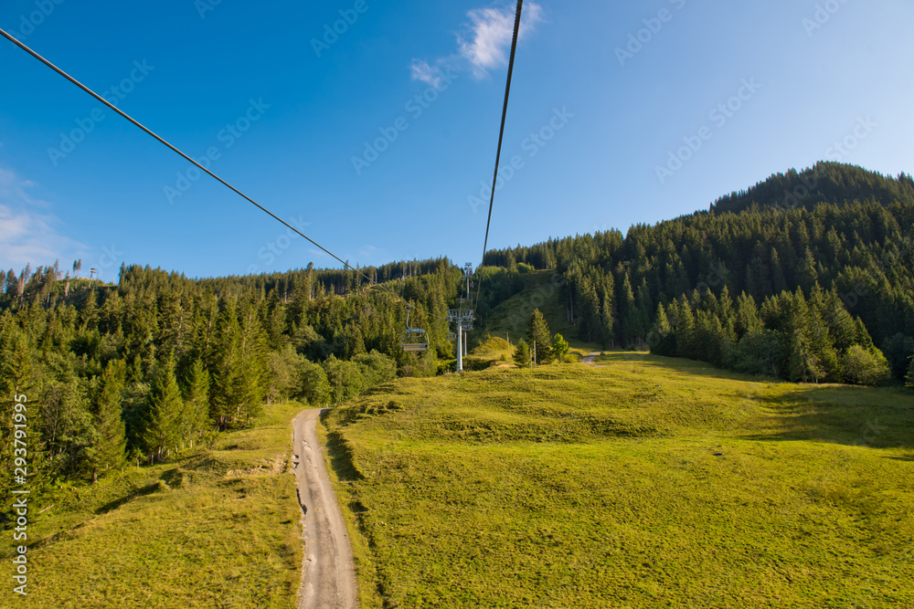 Mountain landscape with forest and ski lift on a sunny day. Mountain landscape with forest and ski lift on a sunny day.