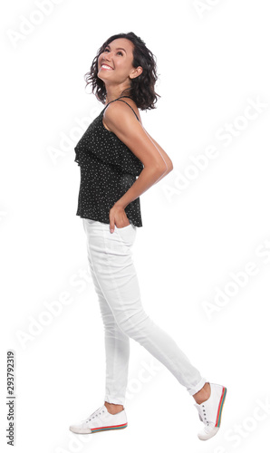 Happy young woman in casual outfit on white background