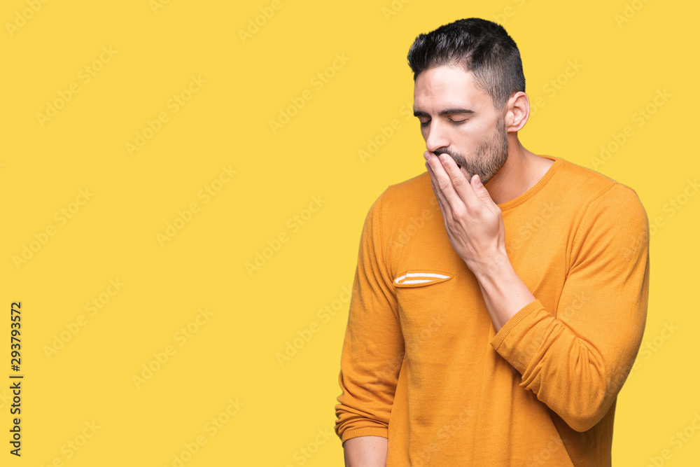 Young handsome man over isolated background bored yawning tired covering mouth with hand. Restless and sleepiness.