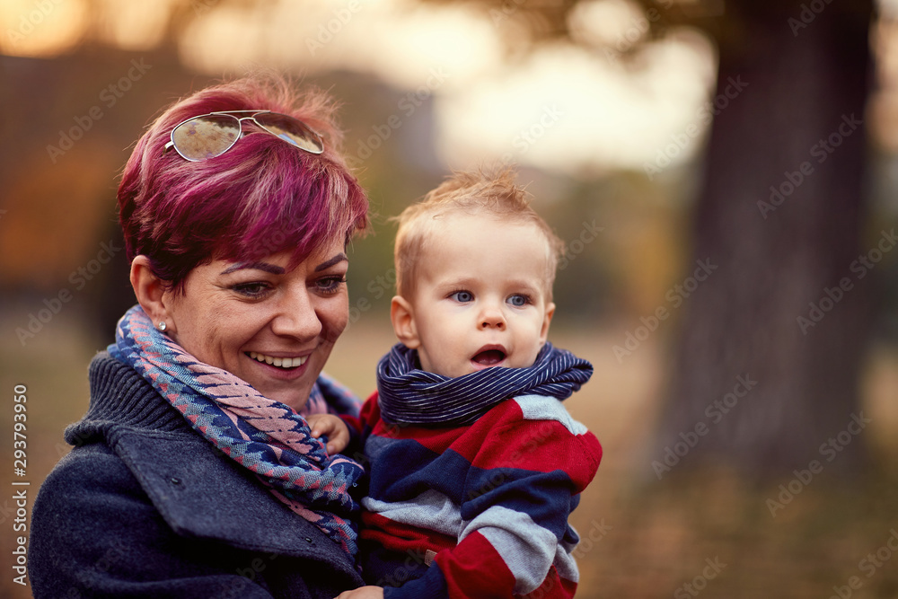 Little boy. Happy childhood. Family. Happy mother with son at the autumn park enjoying together. Little boy. Happy childhood. Family. Happy mother with son at the autumn park enjoying together.