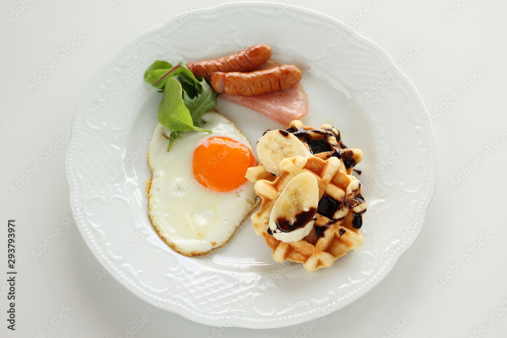 Homemade banana and chocolate waffle with sunny side up egg Homemade banana and chocolate waffle with sunny side up egg