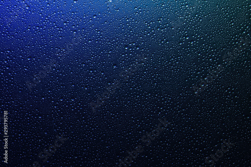 Water droplets on a translucent rainbow glass background with gradient