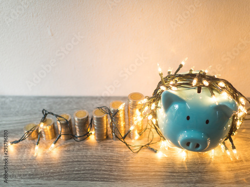 Blue piggy bank with .coins pile growth graph and Party lights, Funly saving money for future investment plan and retirement fund concept photo