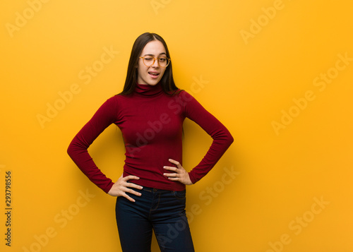 Intellectual young girl winking, funny, friendly and carefree gesture
