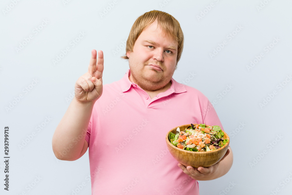 Caucasian crazy blond fat man holding a salad bowl Caucasian crazy blond fat man holding a salad bowl