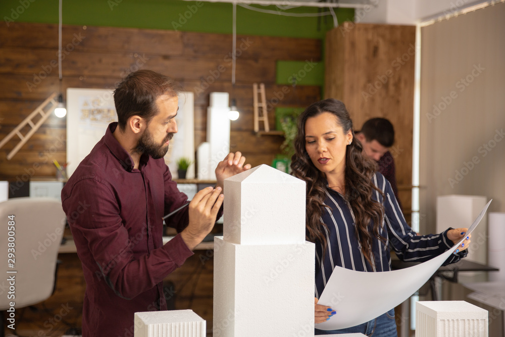 Creative team of architects working on 3D print models Creative team of architects working on 3D print models