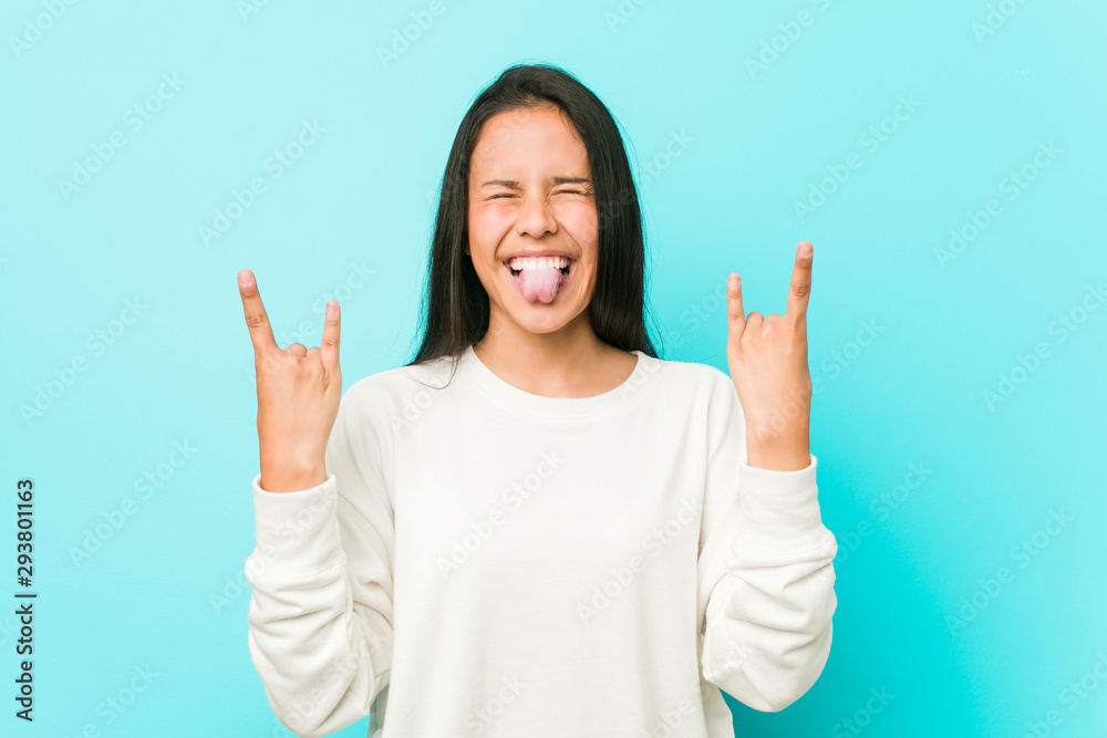 Young pretty hispanic woman showing rock gesture with fingers Young pretty hispanic woman showing rock gesture with fingers