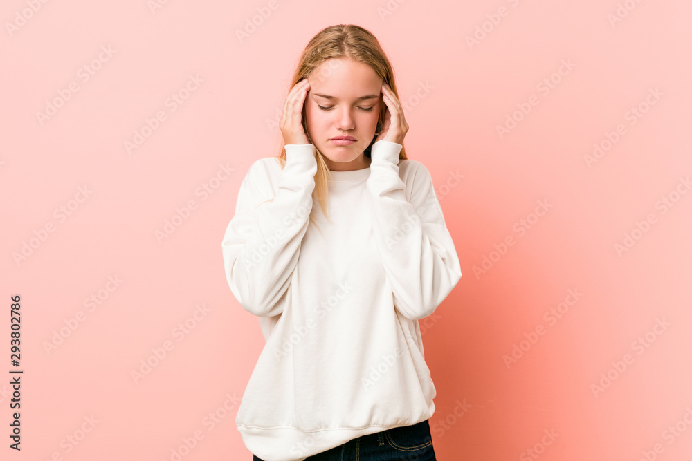 Young blonde teenager woman touching temples and having headache. Young blonde teenager woman touching temples and having headache.