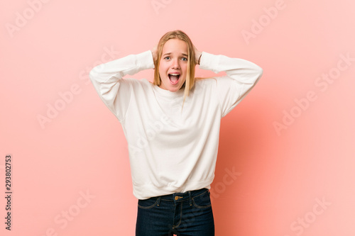 Schilderij op canvas Young blonde teenager woman covering ears with hands trying not to hear too loud sound