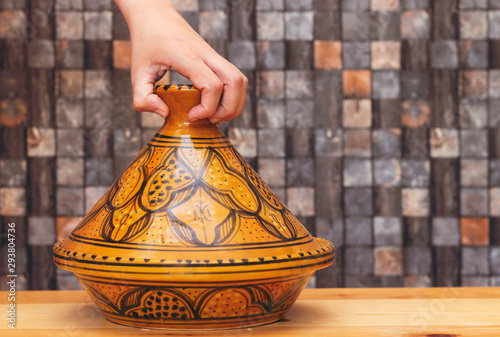 traditional morocco tajine ( means plate in english ) made of clay on wood table photo