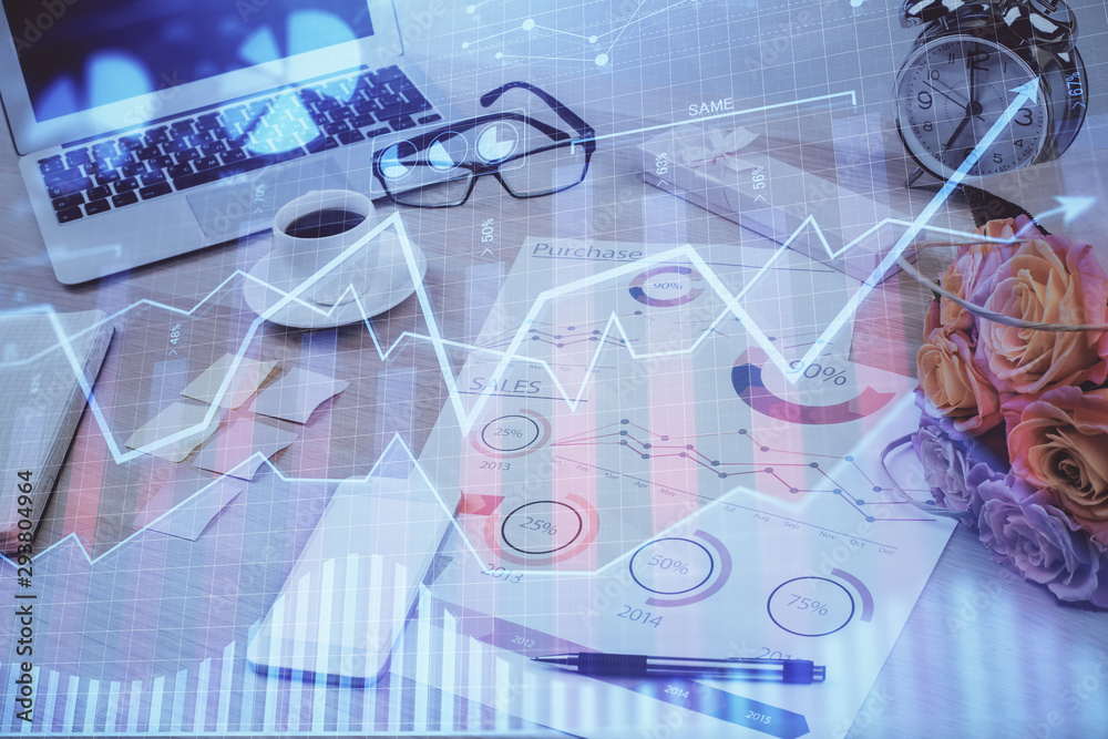 Financial chart drawing and table with computer on background. Double exposure. Concept of international markets. Financial chart drawing and table with computer on background. Double exposure. Concept of international markets.