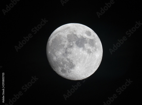 A beautiful close up view of the full moon on a clear night looking up vertical into space