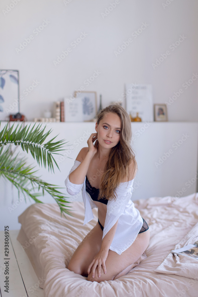 Young sexy girl in lingerie on the bed in the morning Young sexy girl in lingerie on the bed in the morning