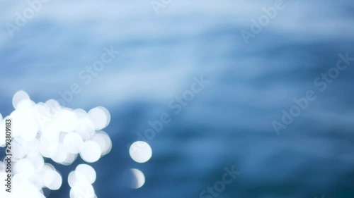 Bokeh reflection from sunlight on the surface of ocean waves video. Beautiful serenade bokeh background. Shaky video on boat