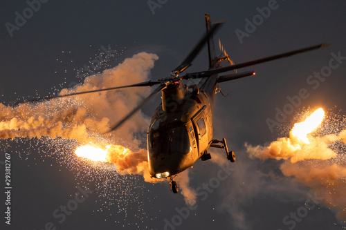Military helicopter firing flares Stock Photo