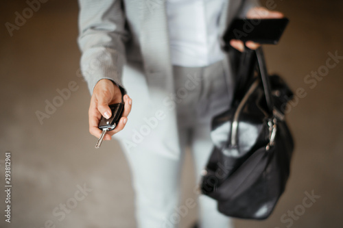 Close up of female hand locking car photo