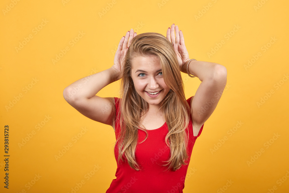 young blonde girl in red t-shirt over isolated orange background shows emotions young blonde girl in red t-shirt over isolated orange background shows emotions