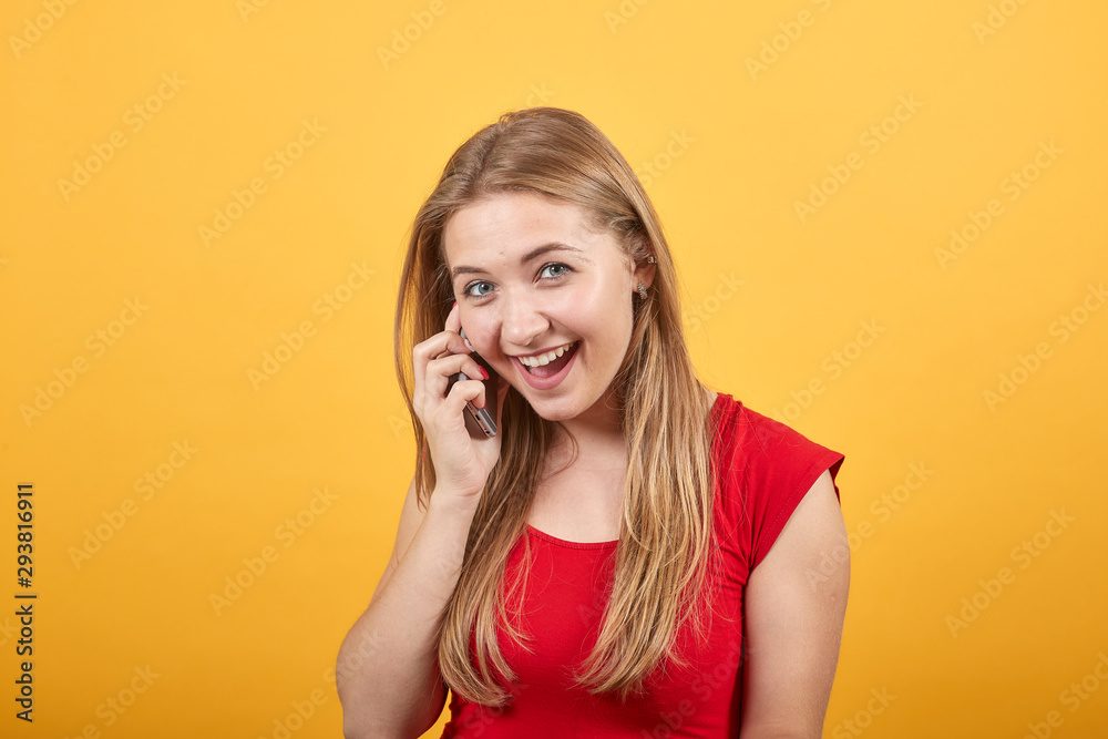 young blonde girl in red t-shirt over isolated orange background shows emotions young blonde girl in red t-shirt over isolated orange background shows emotions