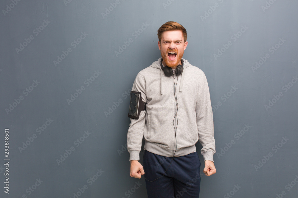 Young fitness redhead man screaming very angry and aggressive Young fitness redhead man screaming very angry and aggressive