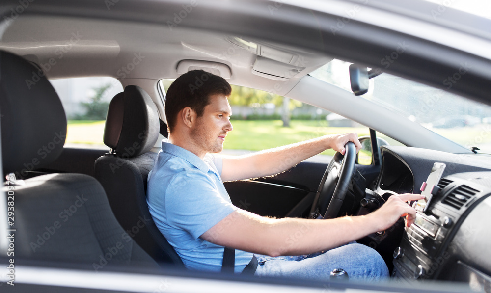 transport, vehicle and people concept - man or driver driving car and using gps navigator transport, vehicle and people concept - man or driver driving car and using gps navigator