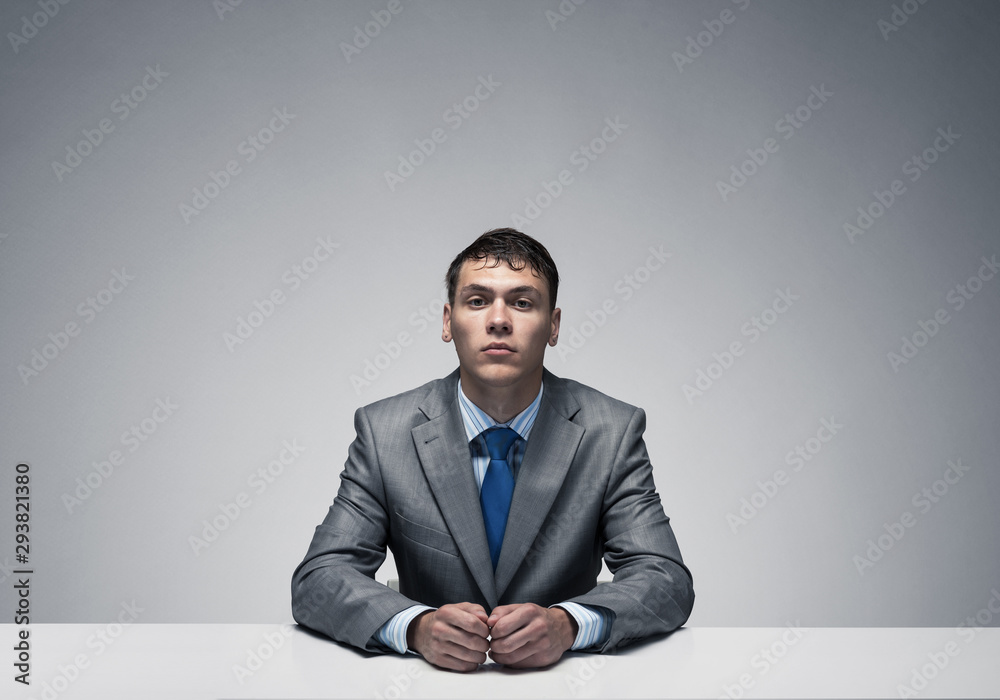 Handsome man folded hands and having serious face Handsome man folded hands and having serious face