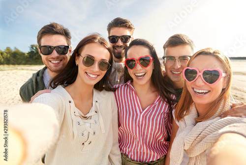 friendship, leisure and people concept - group of happy friends taking selfie on beach in summer © Syda Productions