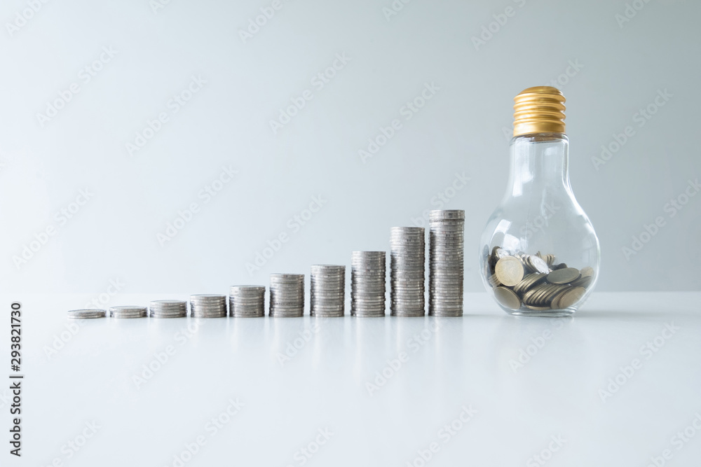 coin in glass bottle bank with coins growth bar graph, step up start up business to suscess, Saving money for future plan and retirement fund concept. coin in glass bottle bank with coins growth bar graph, step up start up business to suscess, Saving money for future plan and retirement fund concept.