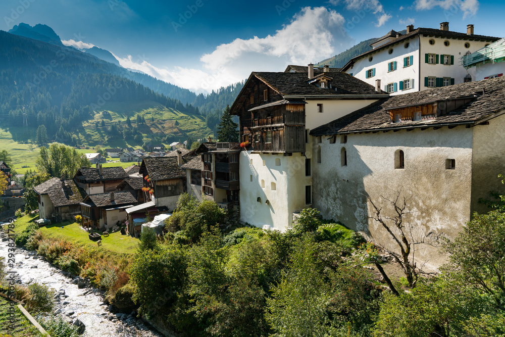 picturesque mountain village with white stone houses and stone roofs in the Swiss Alps