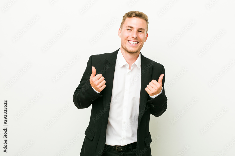 Young caucasian business man raising both thumbs up, smiling and confident. Young caucasian business man raising both thumbs up, smiling and confident.