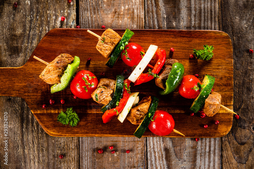 Grilled shashliks with meat on cutting board photo