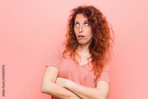 Young natural and authentic redhead woman tired of a repetitive task.