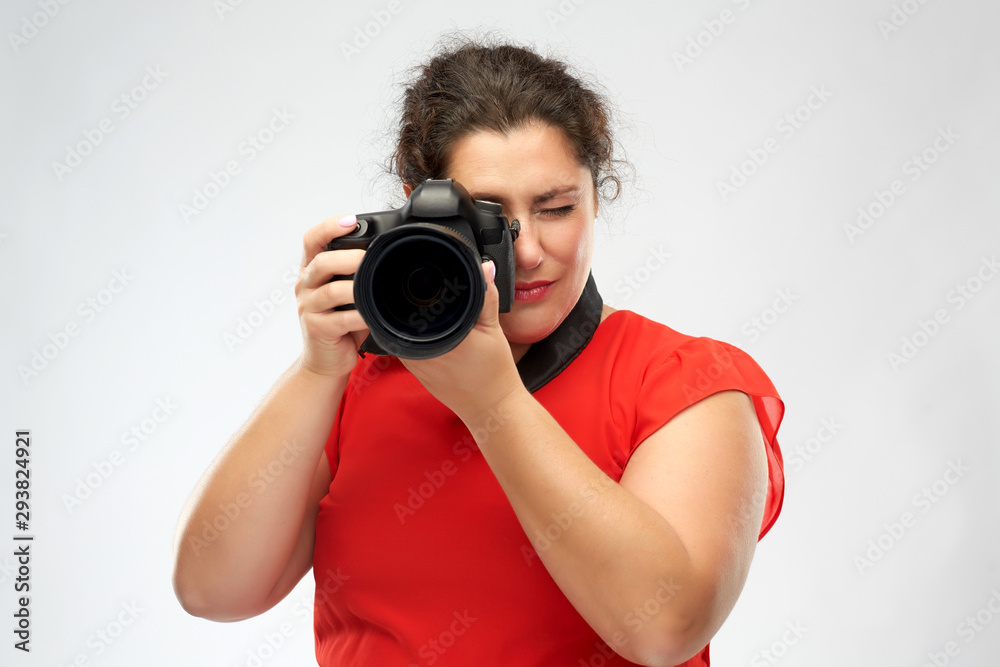 people and photography concept - happy woman photographer in red dress with digital camera over grey background people and photography concept - happy woman photographer in red dress with digital camera over grey background