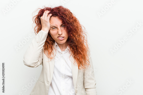 Young natural redhead business woman isolated against white background tired and very sleepy keeping hand on head.