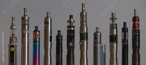 Collection of e-cigarettes or electronic cigarettes for liquid and vaping are displayed on clean backhground photo