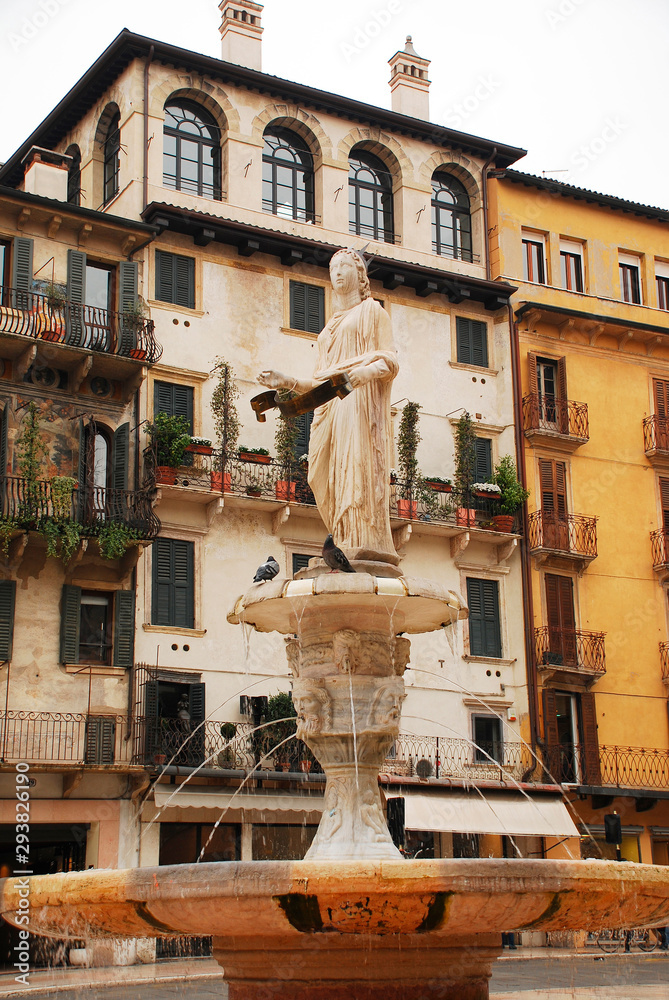 The Roman statue, The Madonna Verona, atop the fountain in Piazza Delle Erbe in Verona, Veneto. The city has been awarded UNESCO World Heritage Site status