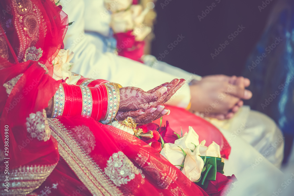 Indian hindu wedding ceremonial ritual items and hands close up